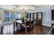 Elegant dining room features a modern chandelier, stylish furnishings, and sliding glass door to the balcony at 1581 Gulf Blvd # 701N, Clearwater Beach, FL 33767