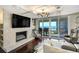 Bright living room boasts a stone fireplace, recessed lighting, and sliding glass doors out to the balcony at 1581 Gulf Blvd # 701N, Clearwater Beach, FL 33767