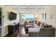 Comfortable living room offers a large sectional sofa, recessed lights, and access to a private balcony at 1581 Gulf Blvd # 701N, Clearwater Beach, FL 33767