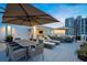 Outdoor living on a luxurious rooftop deck with dining table and lounge seating at 1581 Gulf Blvd # 701N, Clearwater Beach, FL 33767