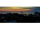 Waterfront house at dusk with boat and tropical vegetation at 160 Shore Dr, Palm Harbor, FL 34683
