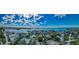 Stunning aerial view of a waterfront community with beautiful homes, lush landscaping, and sparkling waterways at 160 Shore Dr, Palm Harbor, FL 34683