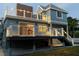 Stunning elevated back deck featuring modern railings, overhead lighting, and steps down to a well-kept backyard at 160 Shore Dr, Palm Harbor, FL 34683