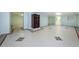 A finished basement with tile flooring offers plenty of space, natural light, and potential for a variety of uses at 160 Shore Dr, Palm Harbor, FL 34683