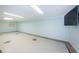 A finished basement features a tile floor and blue paint, providing a versatile and inviting space at 160 Shore Dr, Palm Harbor, FL 34683