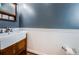 Stylish bathroom with a modern sink, wooden vanity, and wainscoting detail at 160 Shore Dr, Palm Harbor, FL 34683
