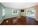 Bright bedroom with hardwood floors, access to the back deck, and a flat screen TV at 160 Shore Dr, Palm Harbor, FL 34683