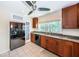 Well-lit kitchen features wood cabinets, granite countertops, and stainless steel appliances at 160 Shore Dr, Palm Harbor, FL 34683