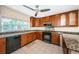 Updated kitchen featuring granite countertops, stainless appliances, tile floor, and wood cabinetry at 160 Shore Dr, Palm Harbor, FL 34683
