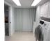 Well-organized laundry room features a modern washer and ample storage cabinets at 160 Shore Dr, Palm Harbor, FL 34683