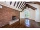 Inviting living room featuring exposed beams, brick fireplace, and large windows for natural light at 160 Shore Dr, Palm Harbor, FL 34683