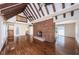 Spacious living room with vaulted ceilings, hardwood floors, and brick fireplace at 160 Shore Dr, Palm Harbor, FL 34683