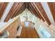 Spacious living room with exposed beams, hardwood floors, and brick fireplace at 160 Shore Dr, Palm Harbor, FL 34683