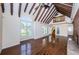 Spacious living room with vaulted ceilings, hardwood floors, large windows and access to upstairs at 160 Shore Dr, Palm Harbor, FL 34683