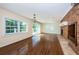 Bright open living room with hardwood floors, brick fireplace, and access to outdoor patio at 160 Shore Dr, Palm Harbor, FL 34683