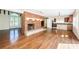 Open-concept living room featuring hardwood floors, fireplace, and open access to the kitchen at 160 Shore Dr, Palm Harbor, FL 34683