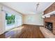Bright living room with brick fireplace and glass sliding door to outside deck at 160 Shore Dr, Palm Harbor, FL 34683