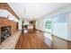 Open-concept living room with fireplace, hardwood floors, and sliding glass doors at 160 Shore Dr, Palm Harbor, FL 34683