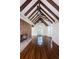 Bright living room with exposed beam ceiling, hardwood floors, brick fireplace and large windows at 160 Shore Dr, Palm Harbor, FL 34683
