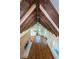 Spacious living room with exposed beams, hardwood floors, and brick fireplace at 160 Shore Dr, Palm Harbor, FL 34683