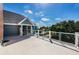 Open patio with white railings and lush green surroundings at 160 Shore Dr, Palm Harbor, FL 34683