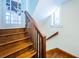 Wooden staircase with classic railing and decorative window at 160 Shore Dr, Palm Harbor, FL 34683