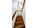 Wooden staircase with handrail leading upstairs at 160 Shore Dr, Palm Harbor, FL 34683