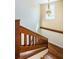 Wooden staircase with decorative chandelier, leading up to the next level of the home at 160 Shore Dr, Palm Harbor, FL 34683