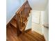 A carpeted staircase features wood handrails, offering a blend of safety and style for the home's interior at 160 Shore Dr, Palm Harbor, FL 34683