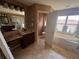 Bright bathroom featuring a soaking tub, separate vanities, and a tiled floor, offering a spa-like experience at 16027 Vine Cliff Ave, Hudson, FL 34667