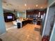 Spacious kitchen boasts stainless appliances, dark cabinets, and seamless flow into living area at 16027 Vine Cliff Ave, Hudson, FL 34667