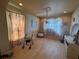 Bright living room with hardwood floors, chandelier, and ornate wall decorations with lots of natural light at 16027 Vine Cliff Ave, Hudson, FL 34667