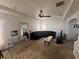 Spacious living room with tray ceilings, a ceiling fan, and large mirror, offering ample space for entertaining at 16027 Vine Cliff Ave, Hudson, FL 34667