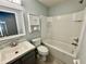 Bathroom featuring white tub, gray vanity with sink, and ample storage with modern fixtures at 1878 Greenwood Valley Dr, Plant City, FL 33563
