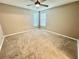 Cozy bedroom with neutral carpet, ceiling fan, and two windows letting in natural light at 1878 Greenwood Valley Dr, Plant City, FL 33563