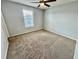 A well-lit bedroom features a neutral color scheme, carpeting, and a single window at 1878 Greenwood Valley Dr, Plant City, FL 33563