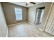 This bedroom is spacious and bright, featuring wood-look flooring and a ceiling fan at 1878 Greenwood Valley Dr, Plant City, FL 33563