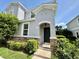 Inviting two-story home featuring a charming front entrance with stone accents and lush landscaping at 1878 Greenwood Valley Dr, Plant City, FL 33563
