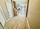 Bright hallway featuring wood-look flooring and views into the kitchen and living areas at 1878 Greenwood Valley Dr, Plant City, FL 33563