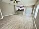 Open-concept living space featuring wood-look flooring, large windows, and a modern kitchen at 1878 Greenwood Valley Dr, Plant City, FL 33563