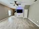 Bright living room with modern ceiling fan, hardwood flooring, and open layout at 1878 Greenwood Valley Dr, Plant City, FL 33563