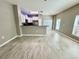 View of living space and kitchen area with hardwood flooring, stainless steel appliances, and bright windows at 1878 Greenwood Valley Dr, Plant City, FL 33563