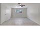 Bedroom features tile floors, a ceiling fan, a window, and natural lighting at 1903 24Th St, Sarasota, FL 34234