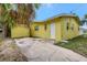 View of yellow exterior and driveway at 1903 24Th St, Sarasota, FL 34234