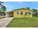 Charming yellow single-story home with a carport and a well-maintained lawn at 1903 24Th St, Sarasota, FL 34234