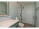 Updated bathroom showcasing glass shower door, modern fixtures, and sleek white and gray tile at 1960 Canadiana Ct, Dunedin, FL 34698