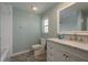 Well-lit bathroom with a tub, white vanity, marble countertops, and modern fixtures at 1960 Canadiana Ct, Dunedin, FL 34698