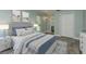 Cozy bedroom with wood-look floors, neutral paint, and a comfortable queen size bed at 1960 Canadiana Ct, Dunedin, FL 34698
