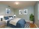 Serene bedroom with cool blue tones, coordinated artwork, and ample natural light at 1960 Canadiana Ct, Dunedin, FL 34698