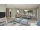 Open-concept living and dining area with wood-look floors and access to a screened-in patio at 1960 Canadiana Ct, Dunedin, FL 34698